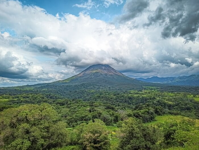 A view over forest-covered landscapes and the conically-shaped Arenal Volcano in Costa Rica