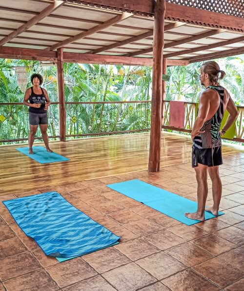 a yoga instructor giving an outdoor yoga class in Santa Teresa, a fun activity to include in your 10 day Costa Rica itinerary