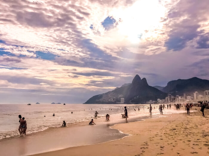 People enjoying a sunny afternoon on Ipanema Beach, a must-see place in every Brazil itinerary