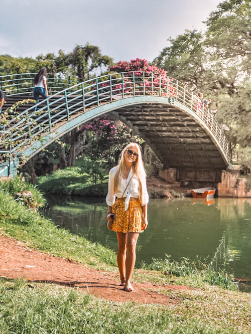 girl standing in front of a bridge in Ibirapuera park