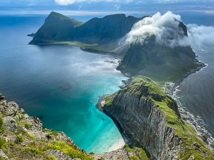 A steep narrow mountain ridge rising from the sea at Værøy, a must-visit place on every Lofoten itinerary.