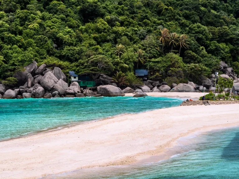 A white sandbank surrounded by turquoise sea and green vegetation at Koh Tao