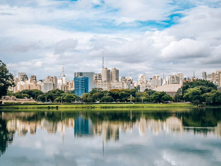 Reflections of Sao Paulo's high-rise buildings on a lake in Ibirapuera Park.