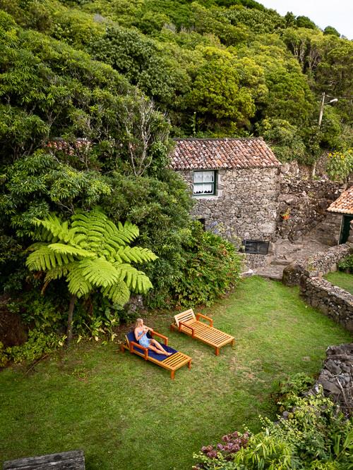 Me lying on a sunbed in the private garden of our stone cottage at Aldeia da Cuada, the best hotel on Flores Island