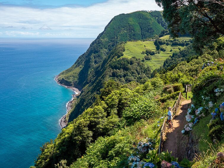 A view of the east coast of Sao Miguel with its steep cliffs covered with lush vegetation.