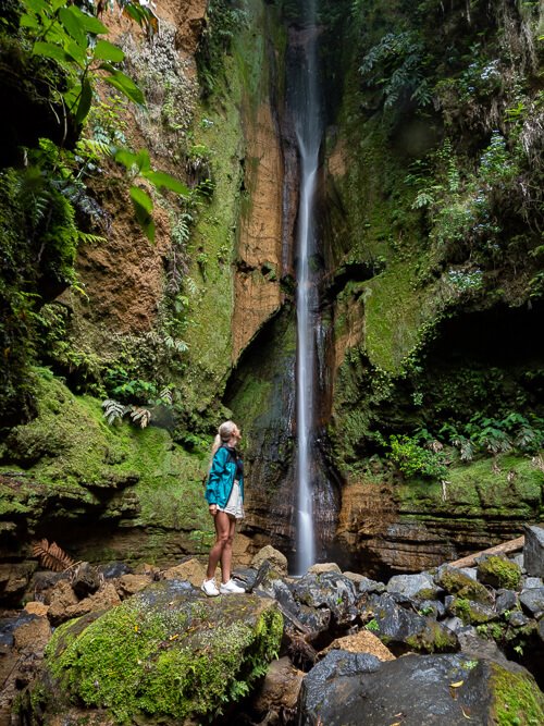 Me looking at the thin Salto do Rosal waterfall, nestled inside a narrow canyon near Furnas