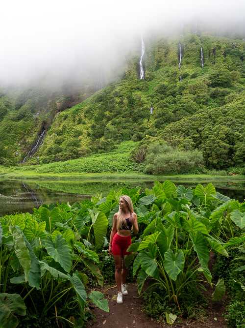 Me posing in front of Poço da Ribeira do Ferreiro pond and waterfalls on a misty day with low clouds.