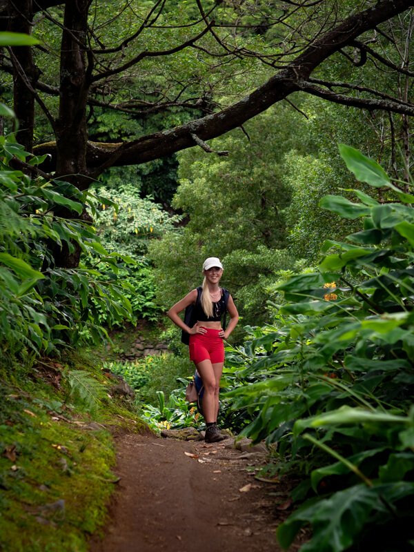 Me standing on a dirt path surrounded by lush greenery on the Sanguinho trail.