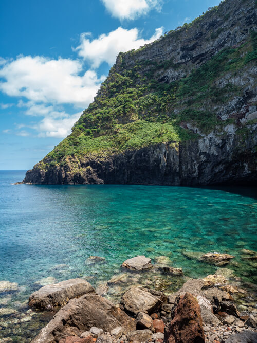 A small bay with vibrant turquoise water at Baia da Alagoa, one of the best beaches on Flores Island, Azores.