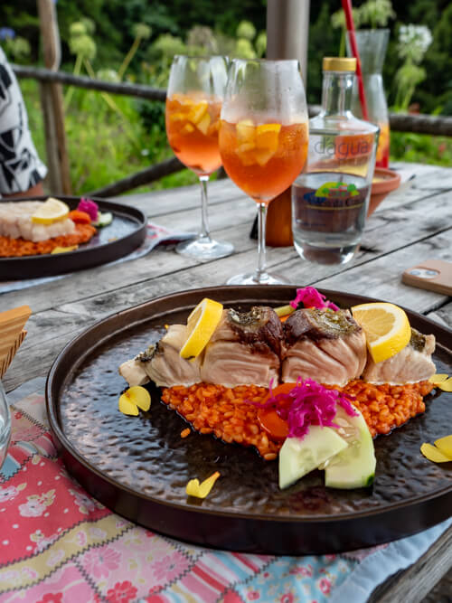 A filet of fish on top of a bed of red risotto in Aldeia da Cuada restaurant.