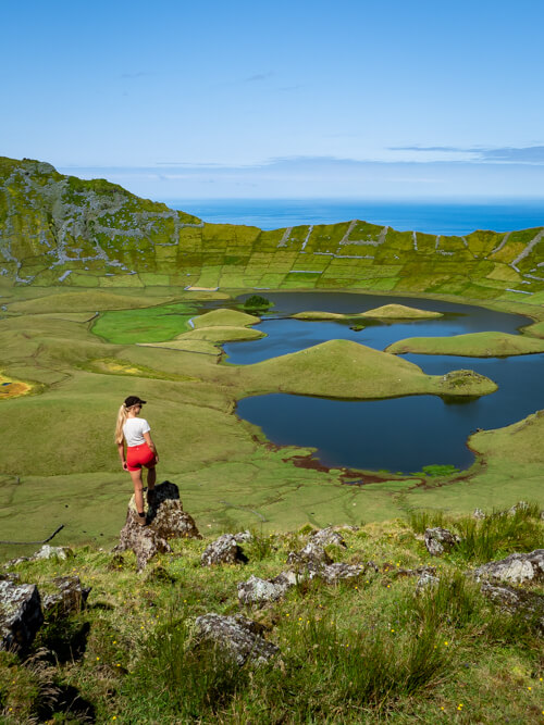 Me balancing myself on a rock overlooking the crater of Caldeirao, the best place to visit in Corvo.